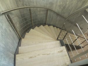 Curved metal staircase with stainless steel balustrade